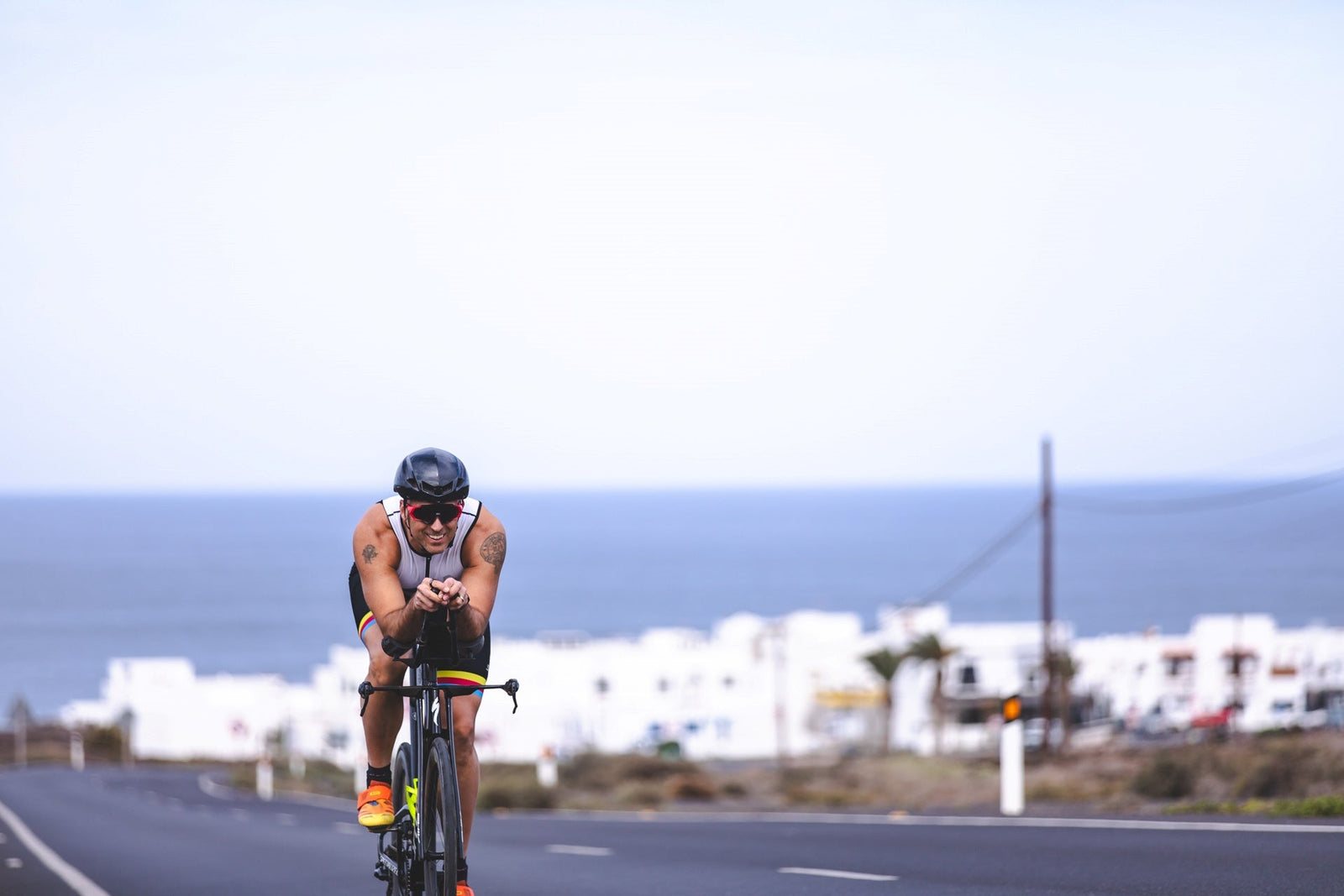 Triathlete performing a cycling training session in a tri suit on a time trial bike, preparing for a sprint triathlon, Olympic-distance triathlon, or Ironman race.